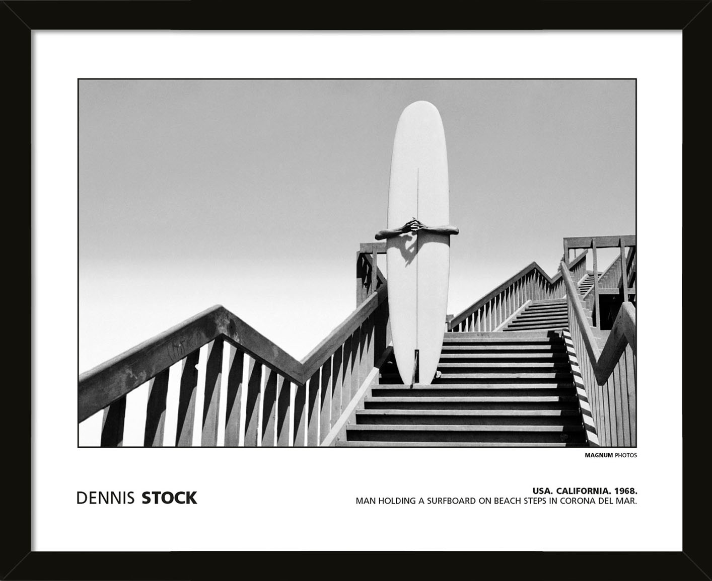 MAGNUM PHOTOS (DENNIS STOCK - USA. CALIFORNIA. 1968. MAN HOLDING A SURFBOARD ON BEACH STEPS IN CORONA DEL MAR.) Pre-Framed Art Poster